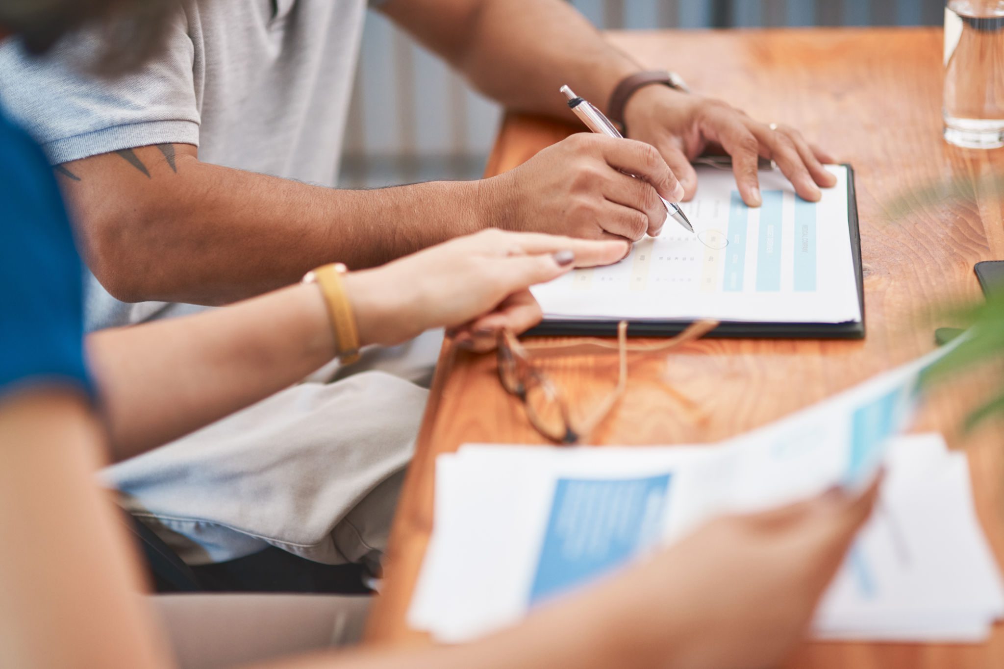 People collaborating and writing notes during a meeting.