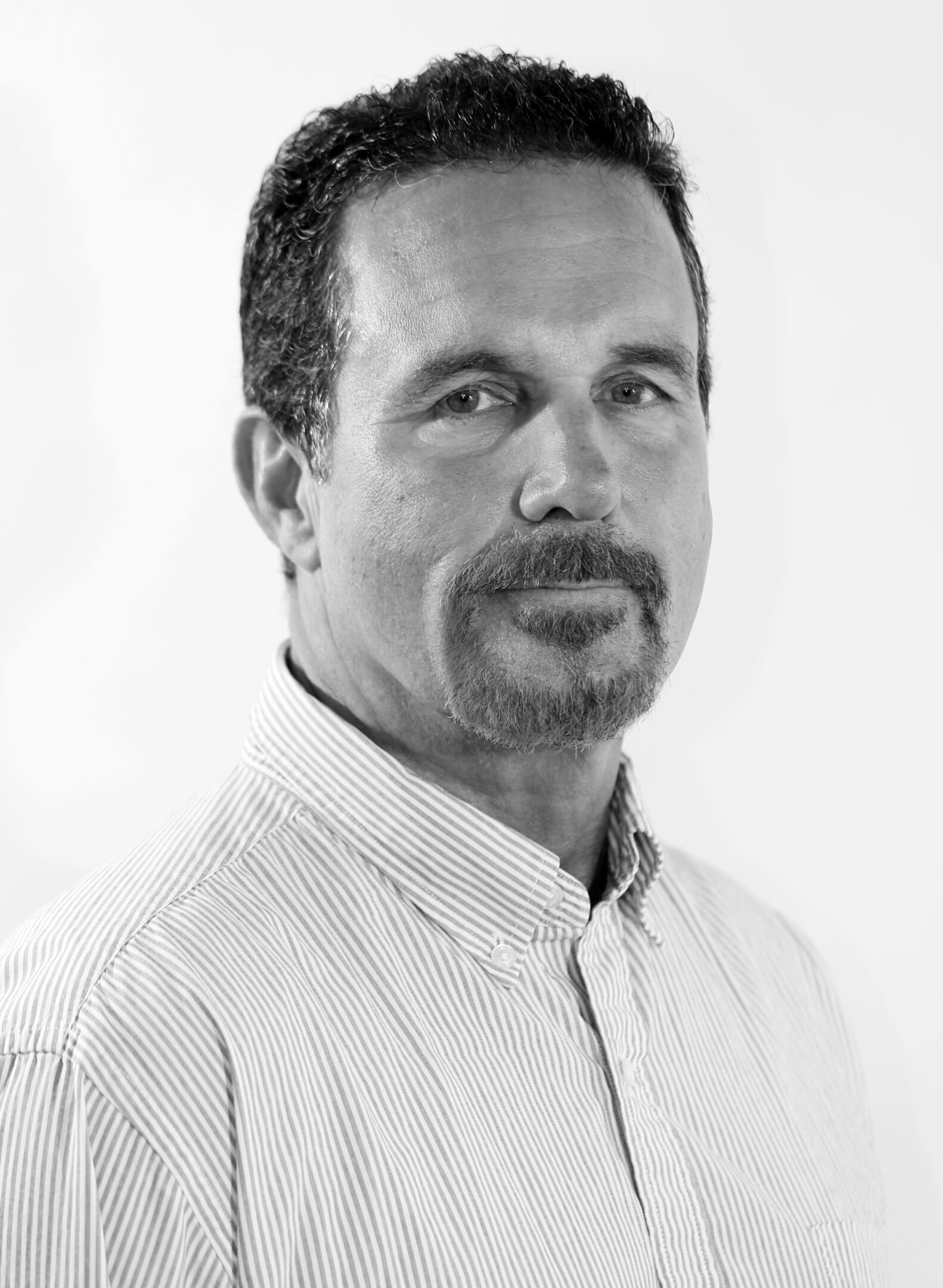 Black-and-white portrait of a man with a mustache and goatee.